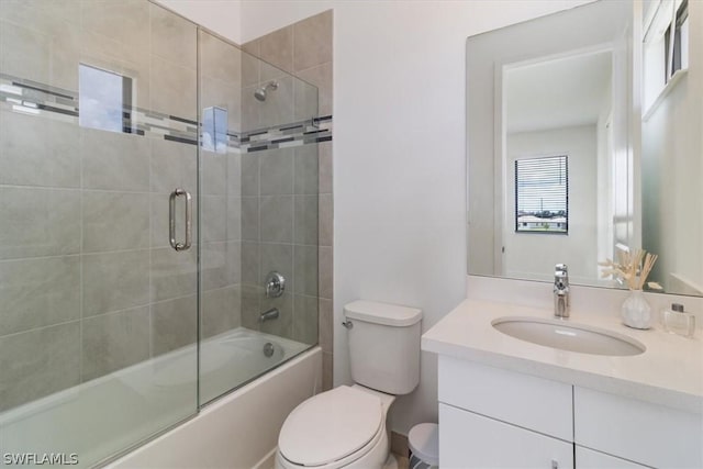 full bathroom with vanity, toilet, and combined bath / shower with glass door