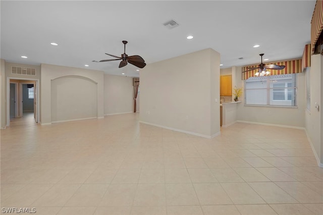 unfurnished living room featuring ceiling fan and light tile patterned floors