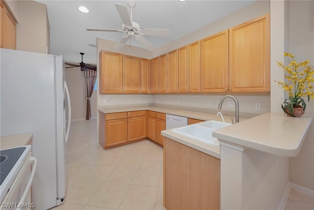 kitchen with light brown cabinets, kitchen peninsula, and white appliances