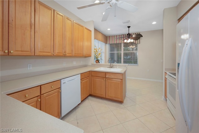 kitchen with ceiling fan, kitchen peninsula, sink, white appliances, and light tile patterned flooring