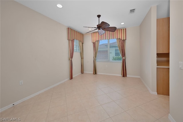 tiled empty room with ceiling fan