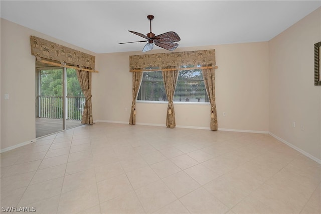 spare room with ceiling fan and light tile patterned flooring