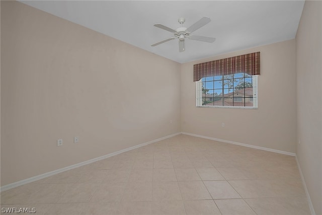 tiled spare room featuring ceiling fan