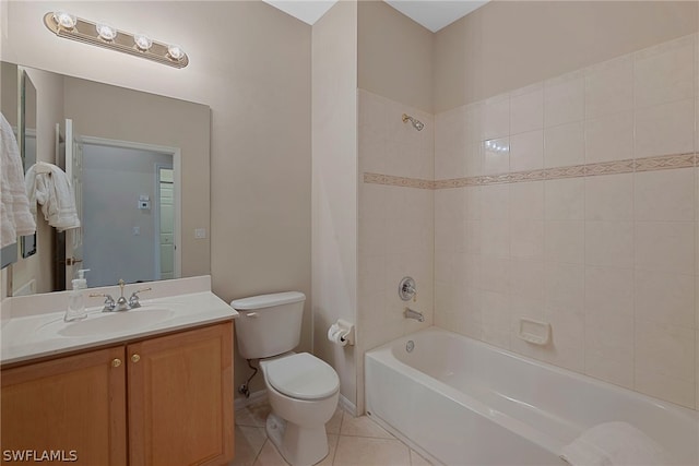 full bathroom with toilet, tiled shower / bath, vanity, and tile patterned floors