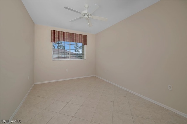 tiled spare room with ceiling fan