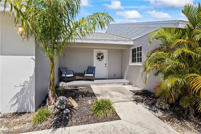 view of exterior entry featuring a patio