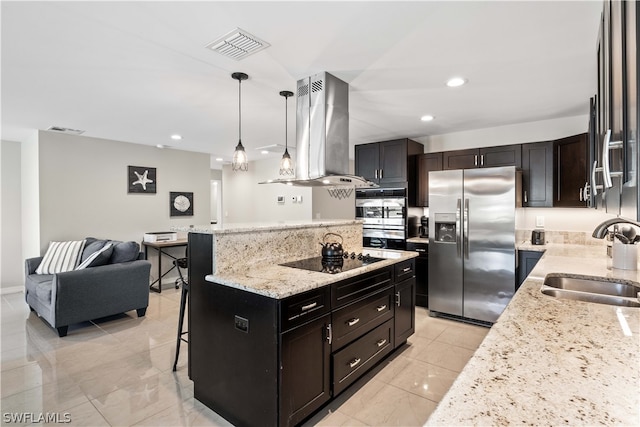 kitchen featuring light tile patterned flooring, appliances with stainless steel finishes, island exhaust hood, pendant lighting, and a kitchen bar