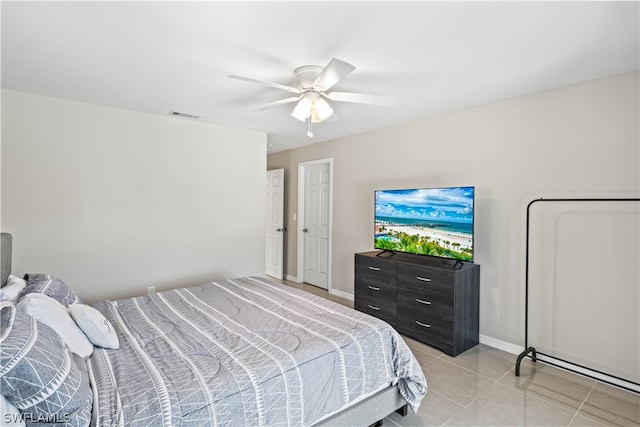 tiled bedroom featuring ceiling fan