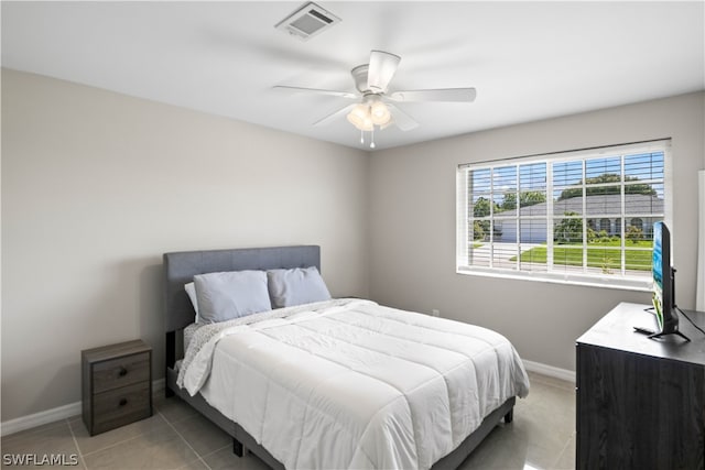 tiled bedroom featuring ceiling fan