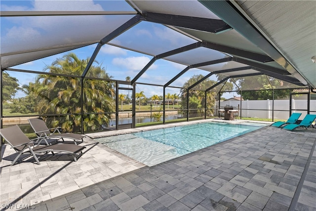 view of swimming pool featuring a patio and a lanai