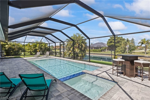 view of pool with a patio and a lanai