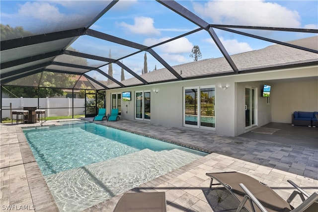 view of swimming pool featuring a patio and a lanai