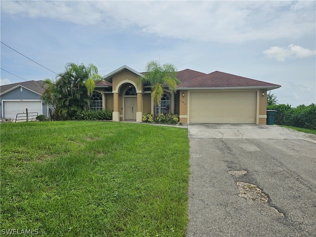 single story home with a garage and a front lawn