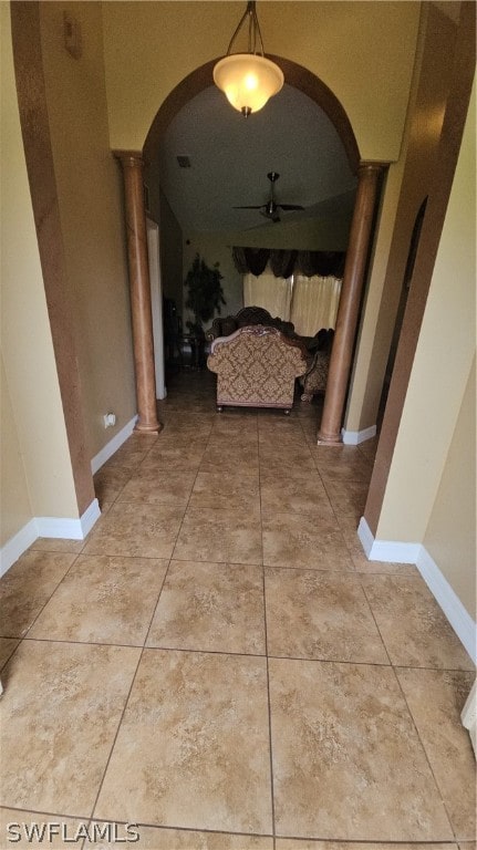 corridor featuring ornate columns and tile patterned flooring