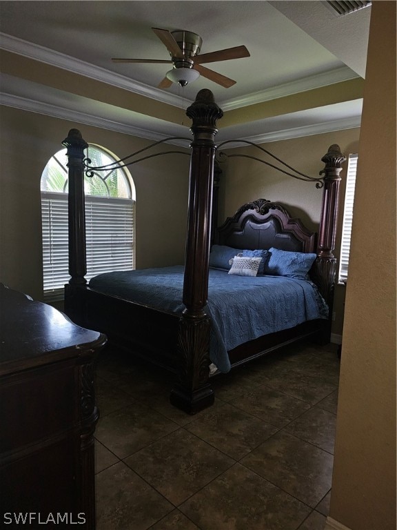 tiled bedroom with ornamental molding and ceiling fan