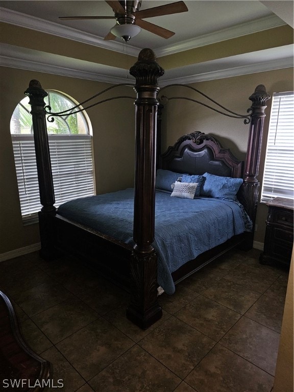 bedroom featuring multiple windows, ceiling fan, dark tile patterned flooring, and ornamental molding