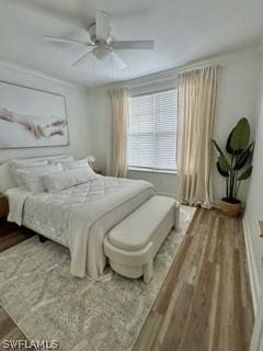 bedroom with hardwood / wood-style floors and ceiling fan