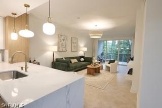 kitchen with sink, kitchen peninsula, and decorative light fixtures