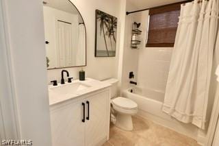 full bathroom featuring toilet, tile patterned floors, vanity, and shower / bathtub combination with curtain