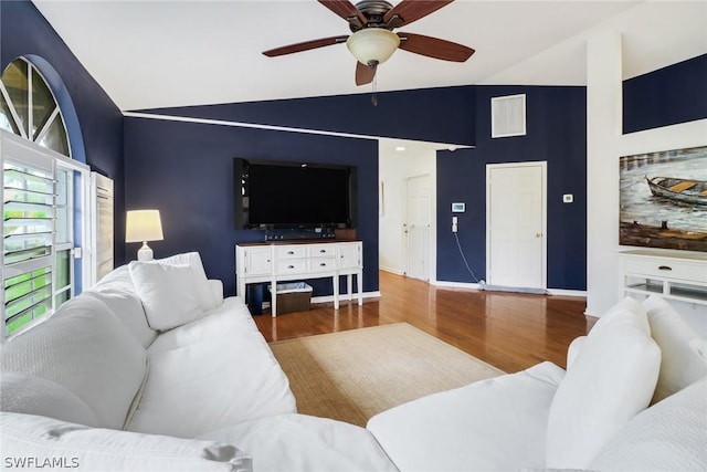 living room with ceiling fan, vaulted ceiling, and wood-type flooring