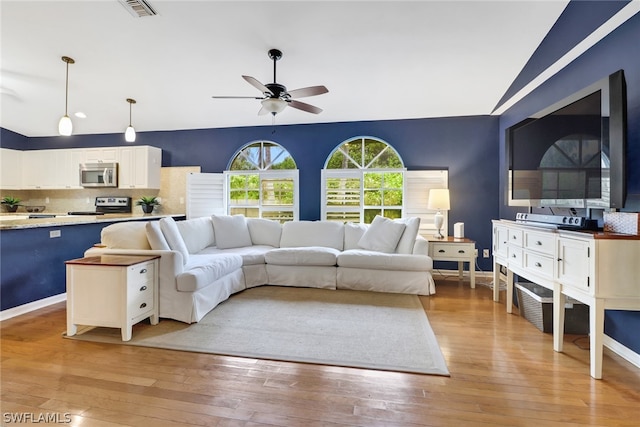 living room featuring ceiling fan and light wood-type flooring