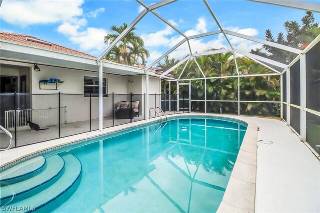 view of pool featuring a lanai and a patio