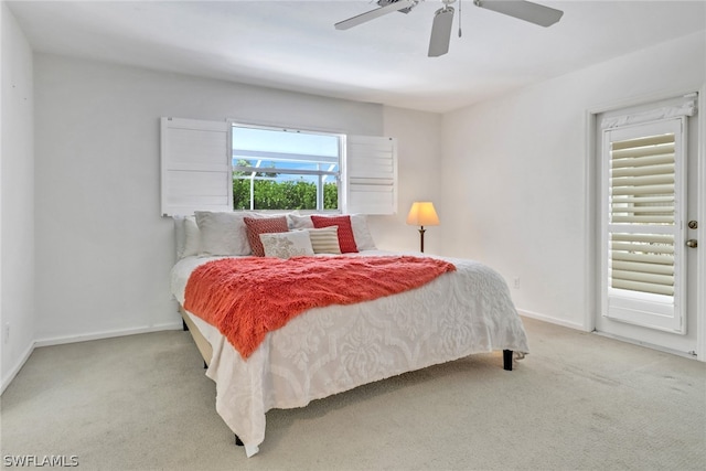 bedroom featuring multiple windows, light carpet, and ceiling fan