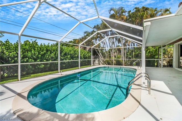 view of swimming pool with a lanai and a patio area