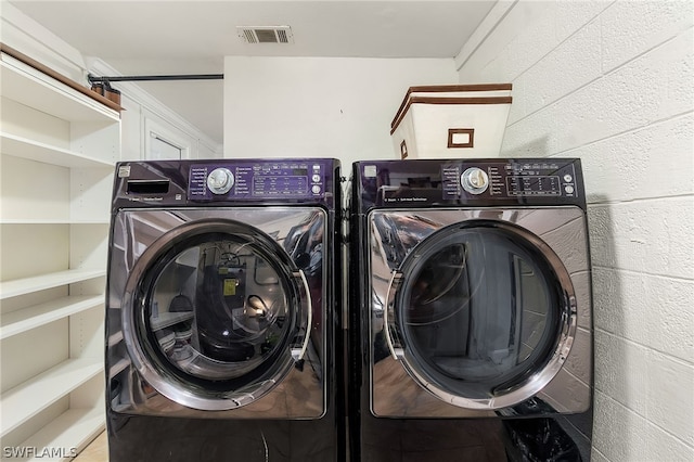 laundry area featuring washing machine and clothes dryer