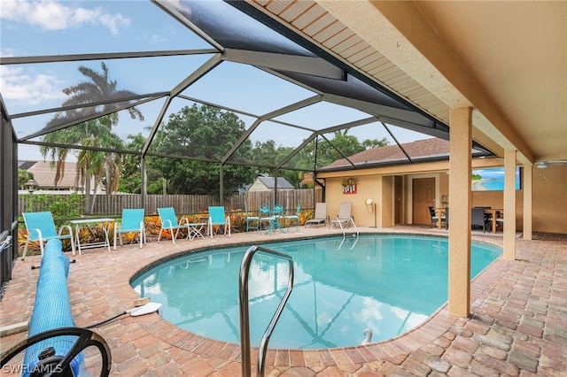 view of swimming pool with a lanai and a patio