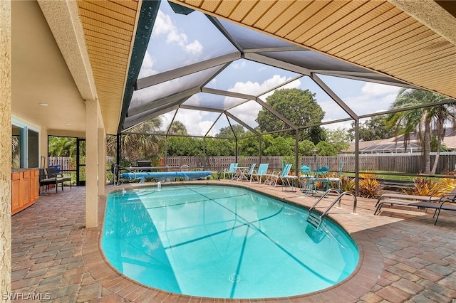 view of swimming pool with a lanai and a patio area