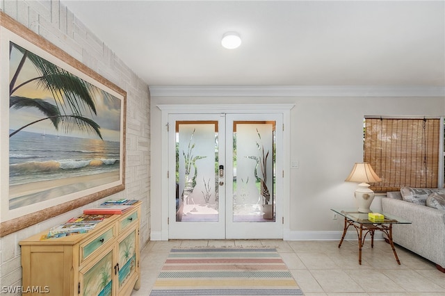 doorway to outside featuring light tile patterned flooring, brick wall, ornamental molding, and french doors