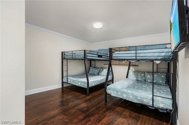 bedroom with crown molding and hardwood / wood-style floors