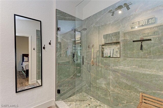 bathroom with walk in shower and a textured ceiling