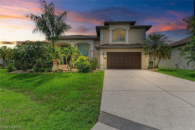 mediterranean / spanish-style home with a lawn and a garage