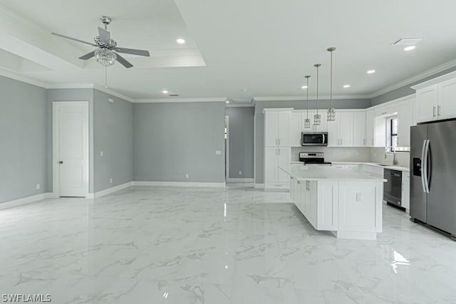 kitchen featuring sink, a center island, appliances with stainless steel finishes, pendant lighting, and white cabinets