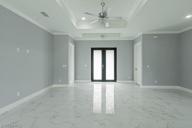 spare room featuring ornamental molding, a tray ceiling, ceiling fan, and french doors