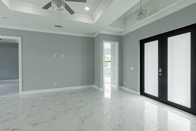 empty room featuring french doors, ornamental molding, a raised ceiling, and ceiling fan with notable chandelier