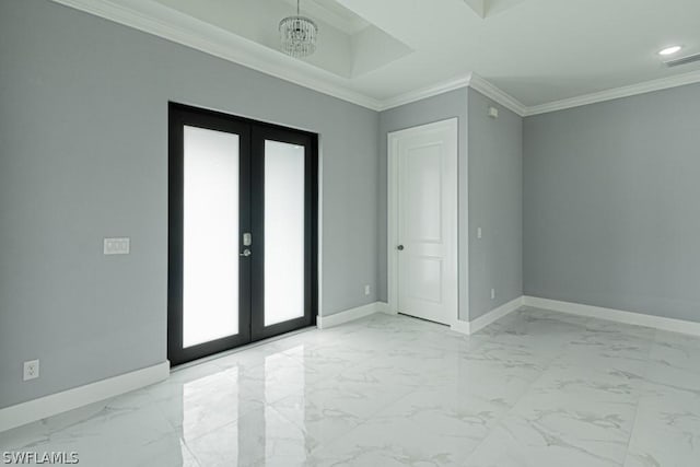 spare room with ornamental molding, an inviting chandelier, and french doors