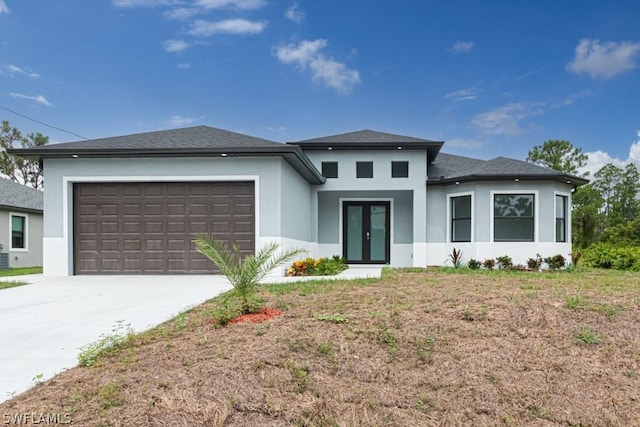 prairie-style home with a garage and french doors