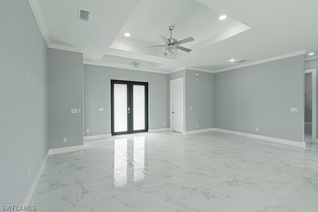 spare room featuring a raised ceiling, ornamental molding, ceiling fan, and french doors