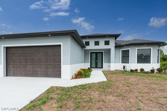 prairie-style house with french doors and a garage