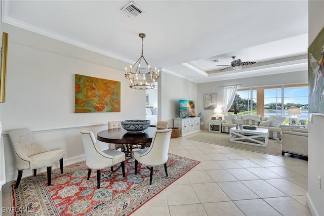 dining space with crown molding, light tile patterned floors, and ceiling fan with notable chandelier