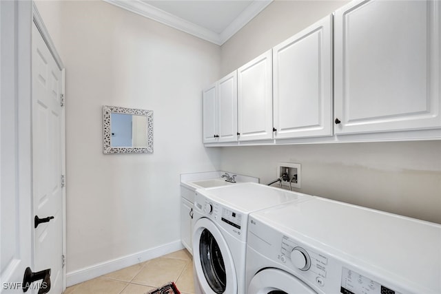 laundry area with cabinets, sink, independent washer and dryer, ornamental molding, and light tile patterned flooring