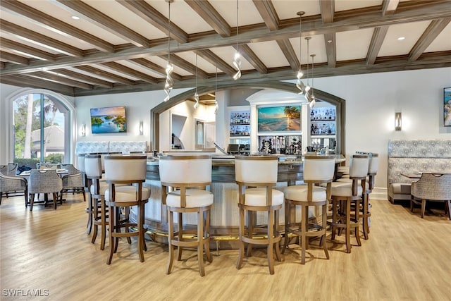 bar featuring beam ceiling, light hardwood / wood-style flooring, pendant lighting, and coffered ceiling