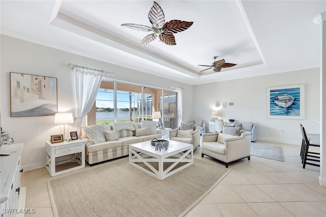 tiled living room featuring a raised ceiling and ceiling fan