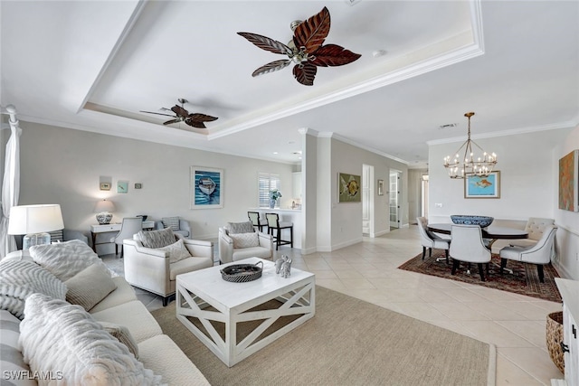 tiled living room featuring ceiling fan with notable chandelier, a raised ceiling, and ornamental molding