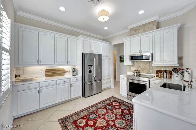 kitchen featuring white cabinets, appliances with stainless steel finishes, and sink