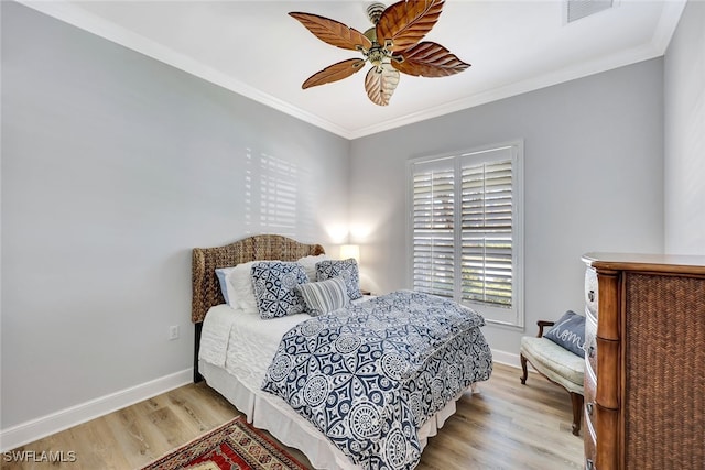 bedroom featuring ceiling fan, crown molding, and light hardwood / wood-style floors