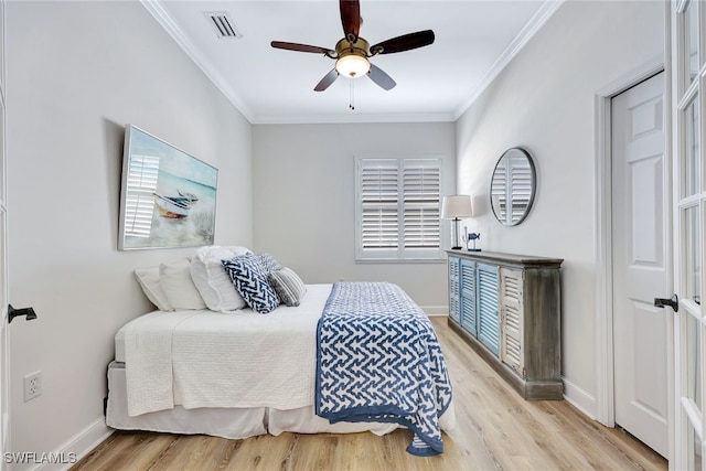 bedroom with light hardwood / wood-style flooring, ceiling fan, and crown molding